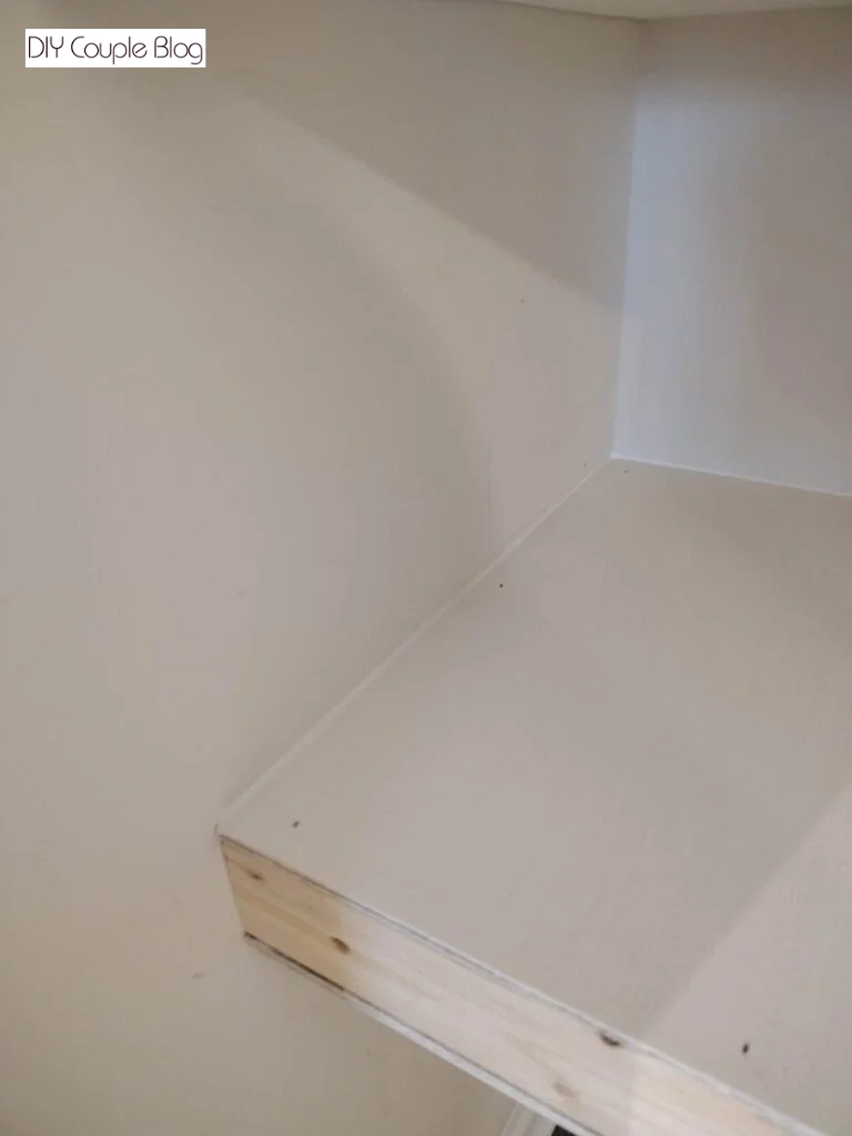 caulking the sides of the shelving for a polished look