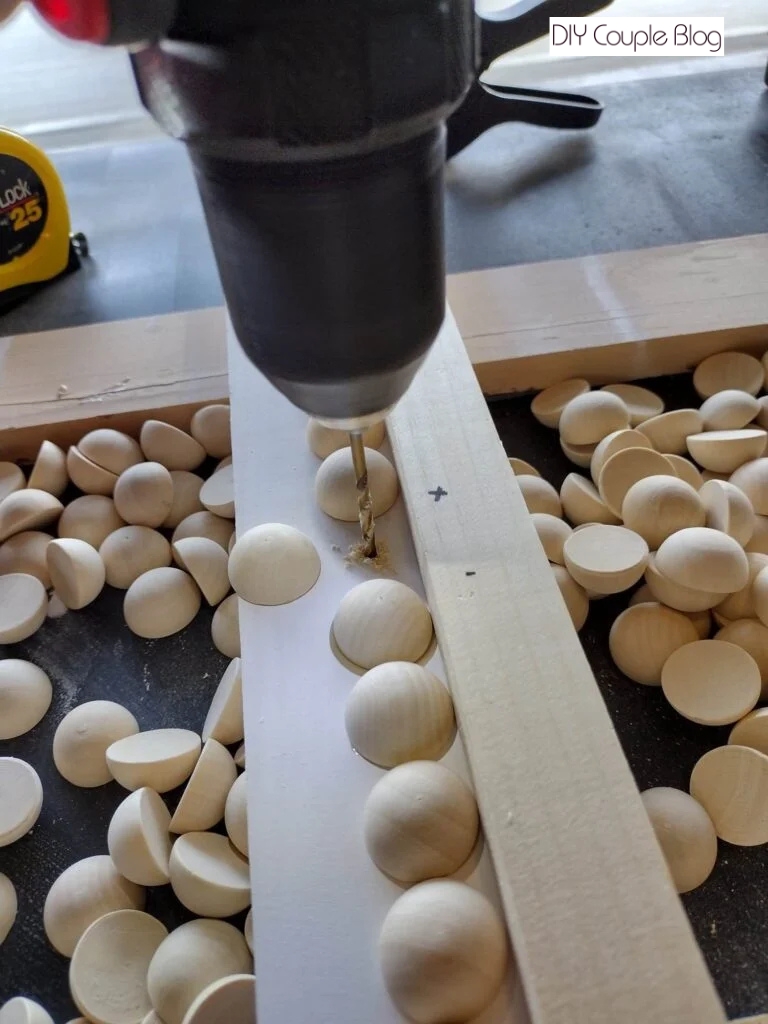 marking and drilling hole to make DIY pantry shelving