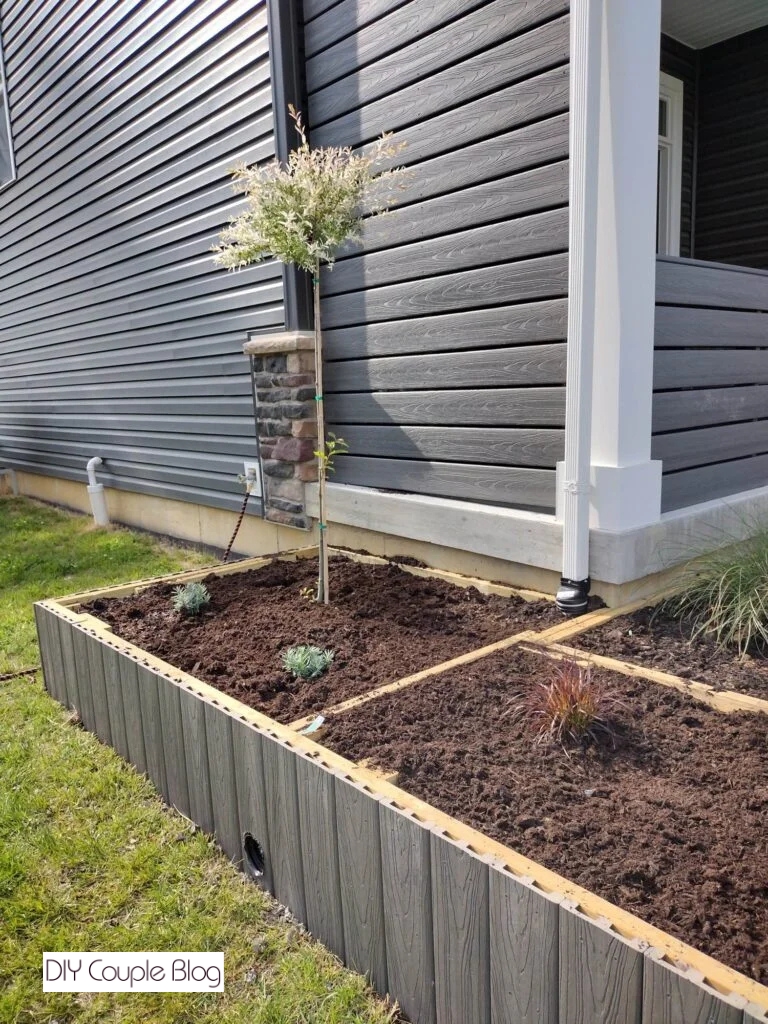 raised flower bed with gutter drain coming out