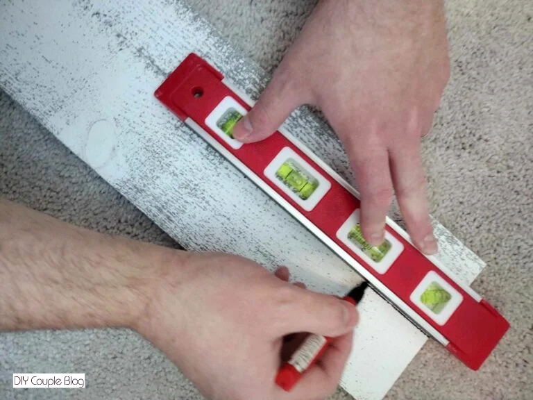 using a level and a marker to make the marking on wood