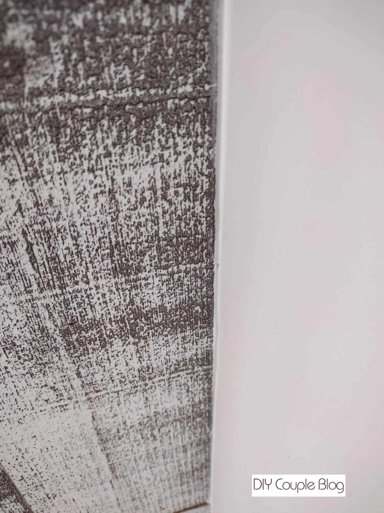filling the seam between the barn wood and the wall