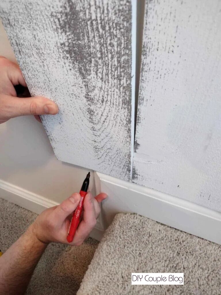notching out sections to fit our wood accent wall perfectly