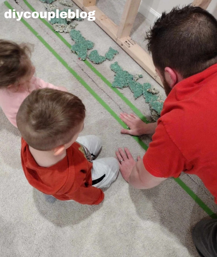 removing carpet padding in the basement floor where playground construction will go