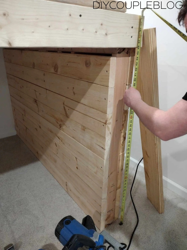 using measuring tape to measure the front face section of the platform walls