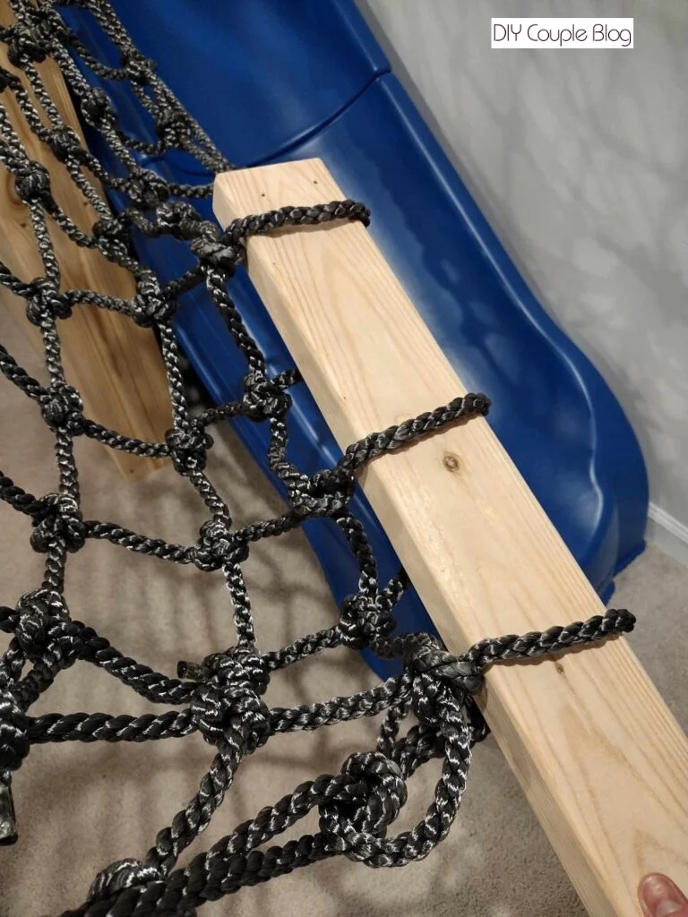 cargo net ran through wood board 