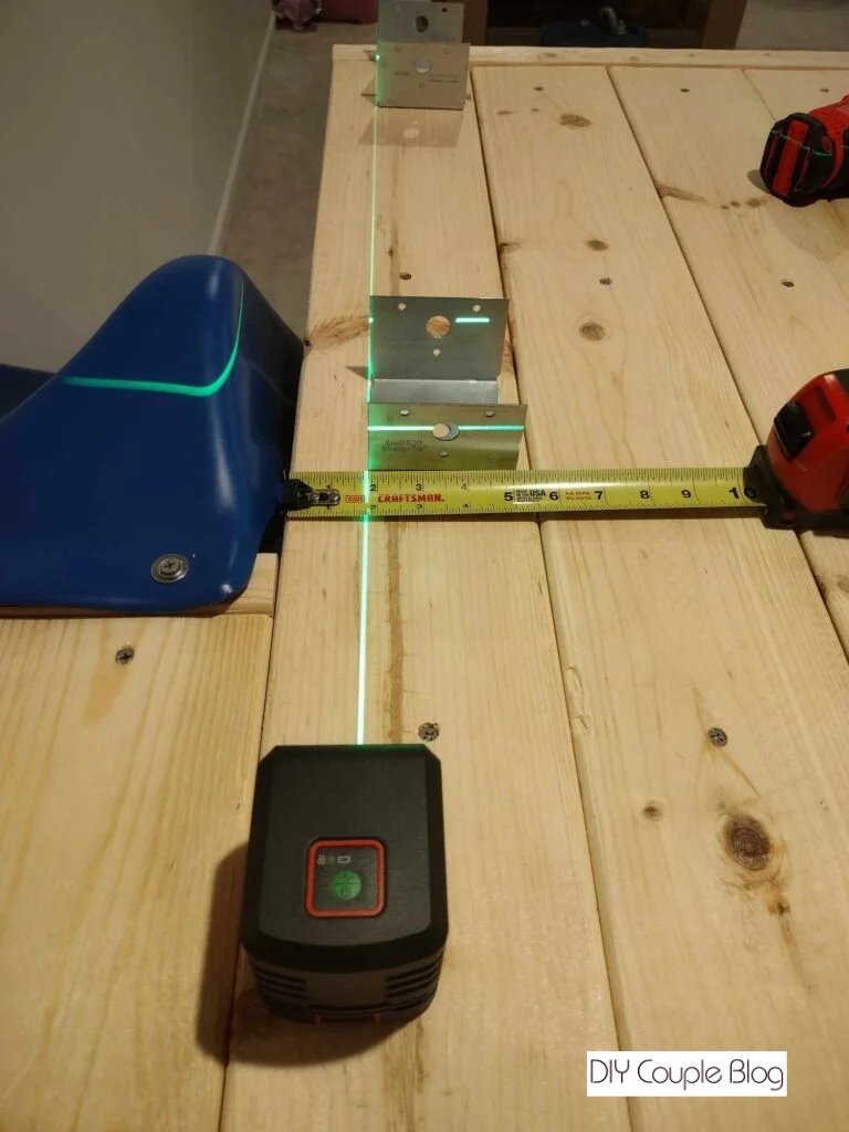 using a laser level to mark the sections for installation 