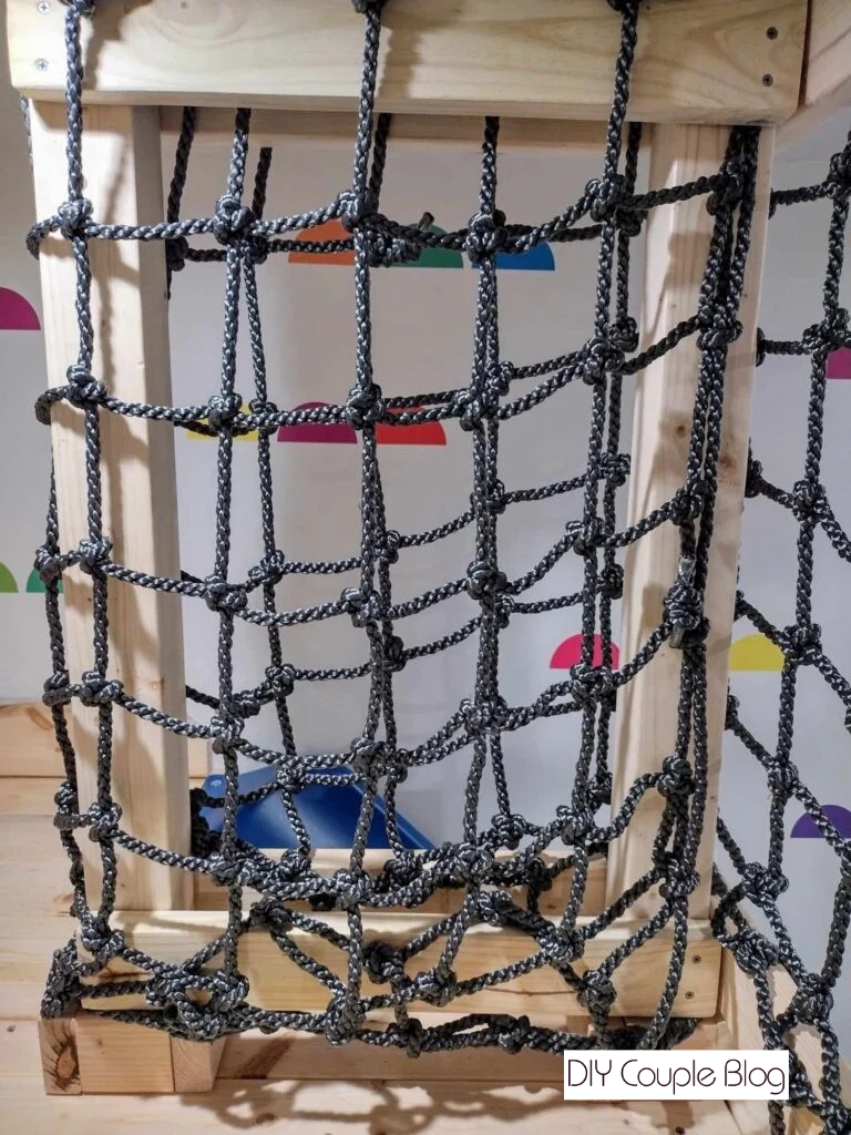process of adding a cargo net to a wood playground railing 