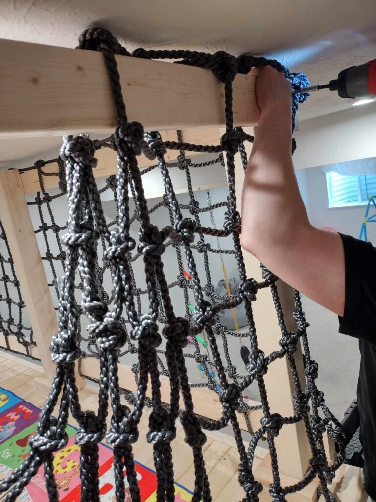 indoor play area ideas: attaching cargo net railing to playground platform