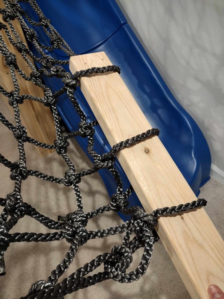 building an indoor playground at home: weaving the cargo net through the wood