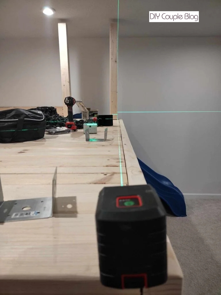 laser level lining up the next posts in front 
