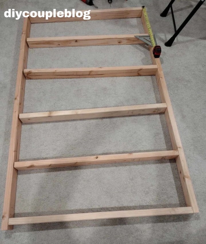 constructing a frame to be the bottom wall support of the jungle gym