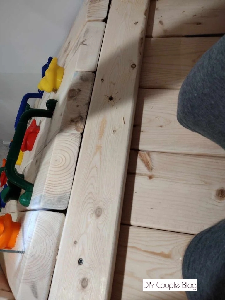 installing diy rock wall to the wood playground 