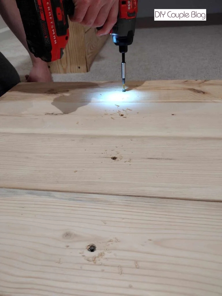 sinking screws into the wood 