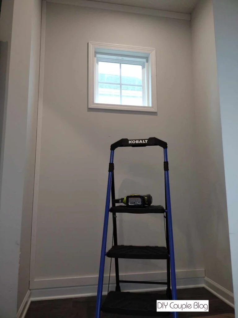 small window in mudroom with new window trim