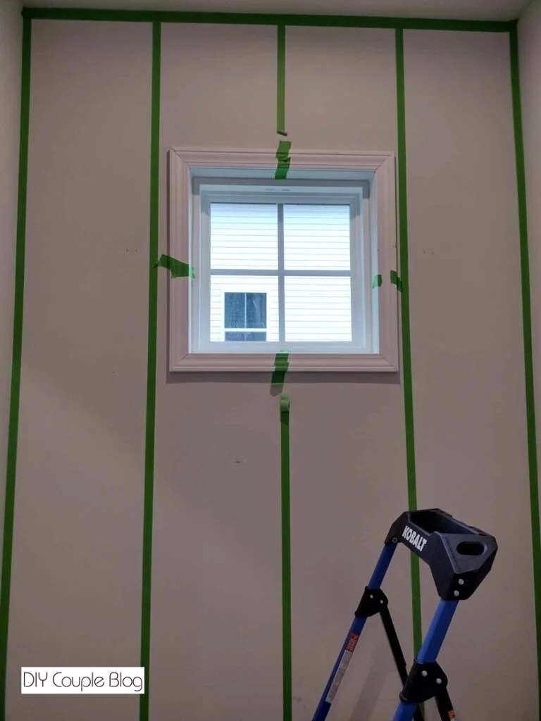 securing the window trim with frog tape for easy installation