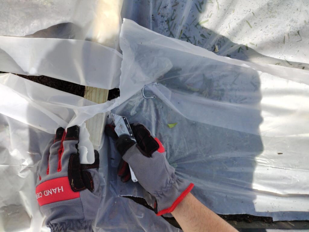 cutting the plastic sheet with a razor knife
