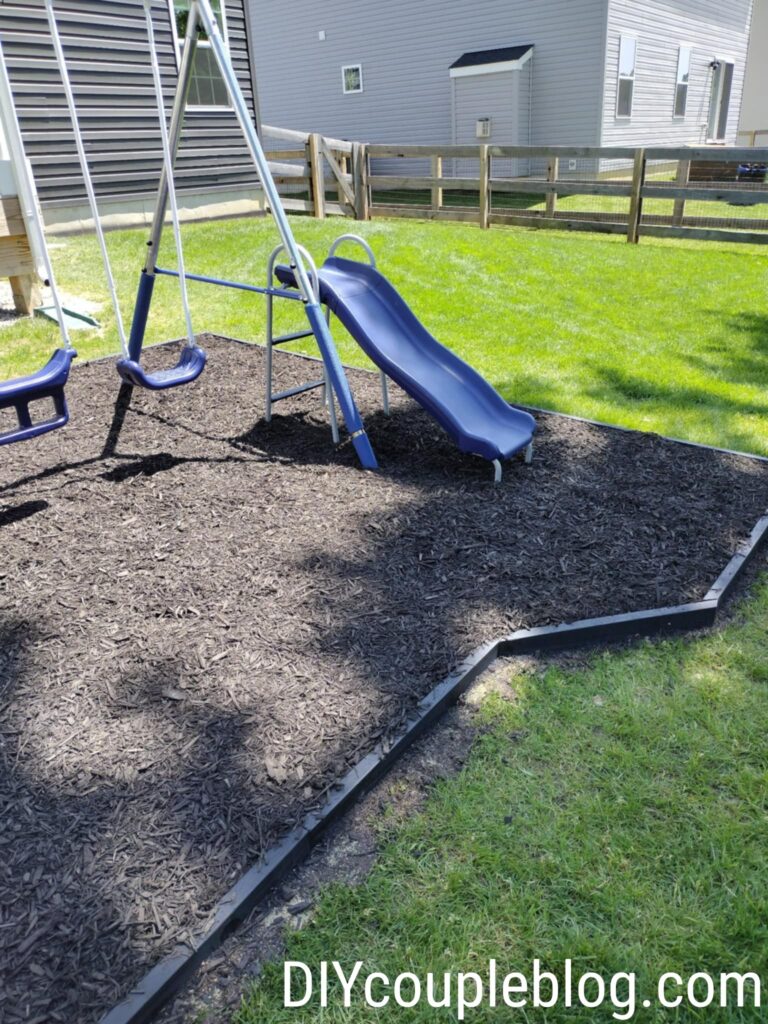 playground border where we extended the edge to make more room when the kids go down the slide