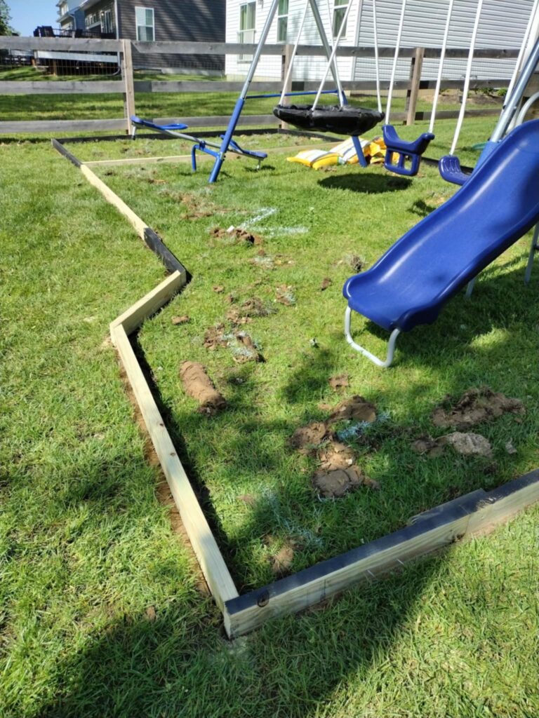 extended playground border in the front of the slide 