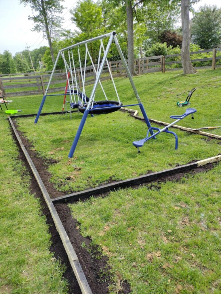 adding dirt all the way around our playground area