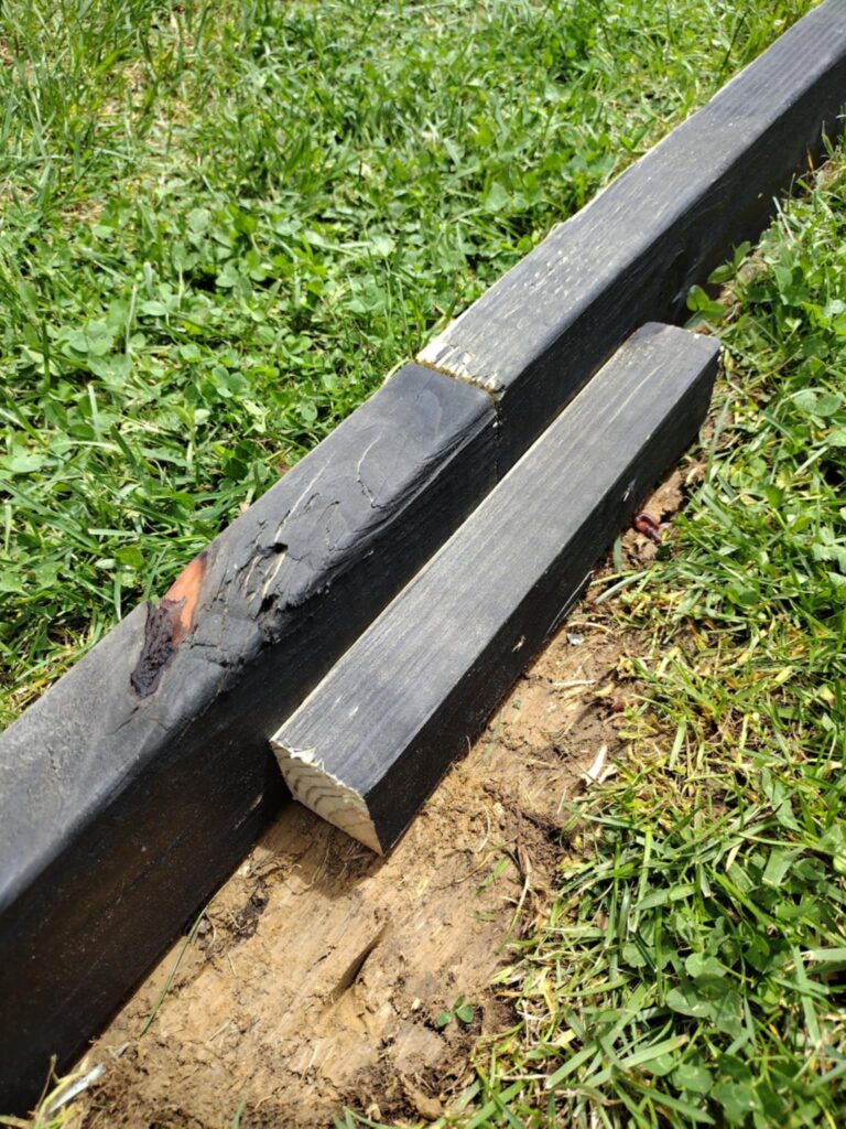 building a playground area border with 2x4 treated wood boards and scrap to connect