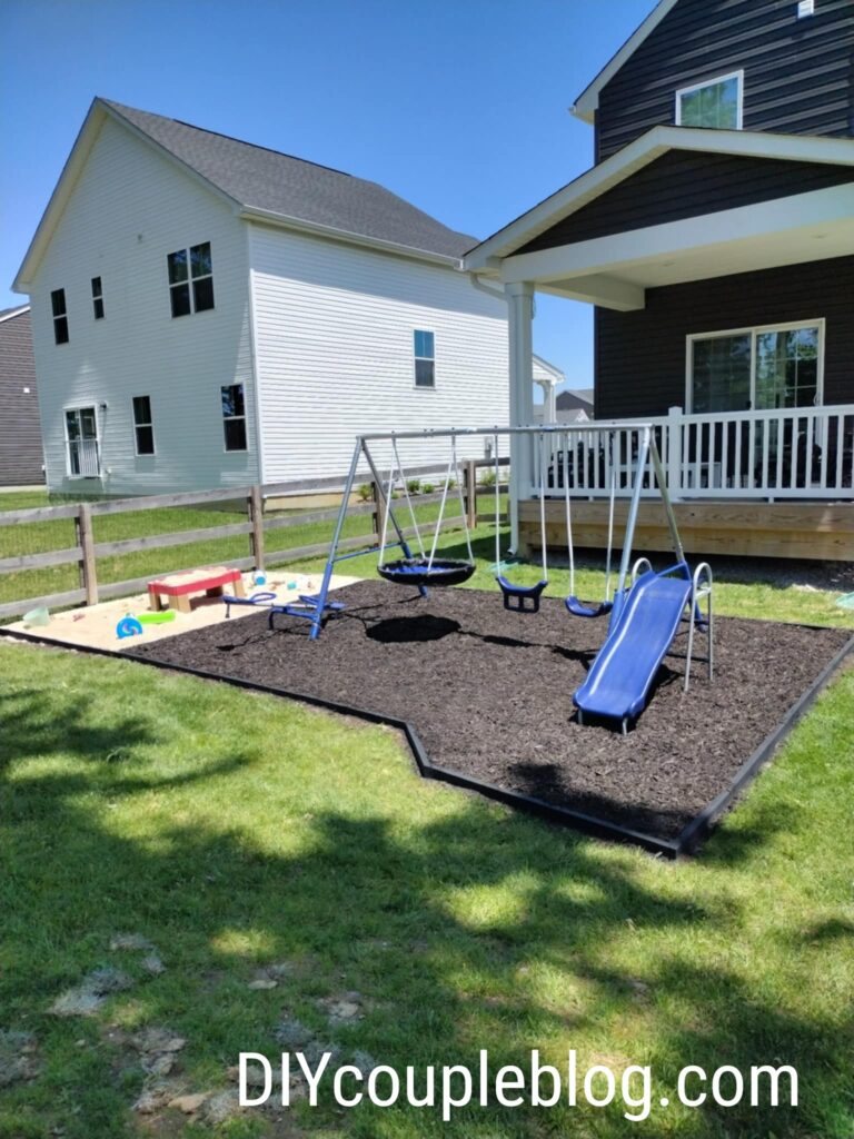 large playground area with mulch and sand and where we used wood to border around and separate the two play areas