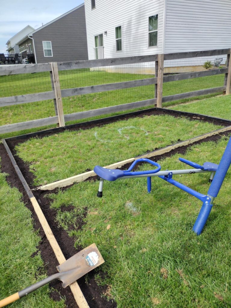 showing the other angle where we used a bag of dirt to fill in any gaps for our playground edging