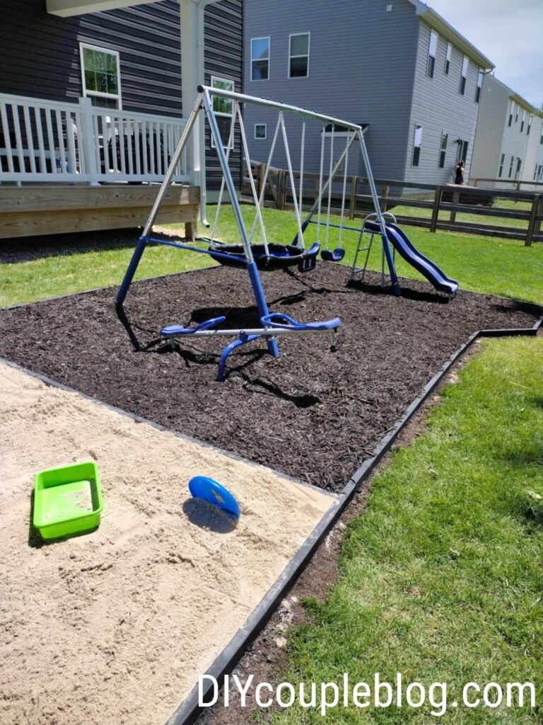 showing where the sandbox meets up with the mulch playground edging