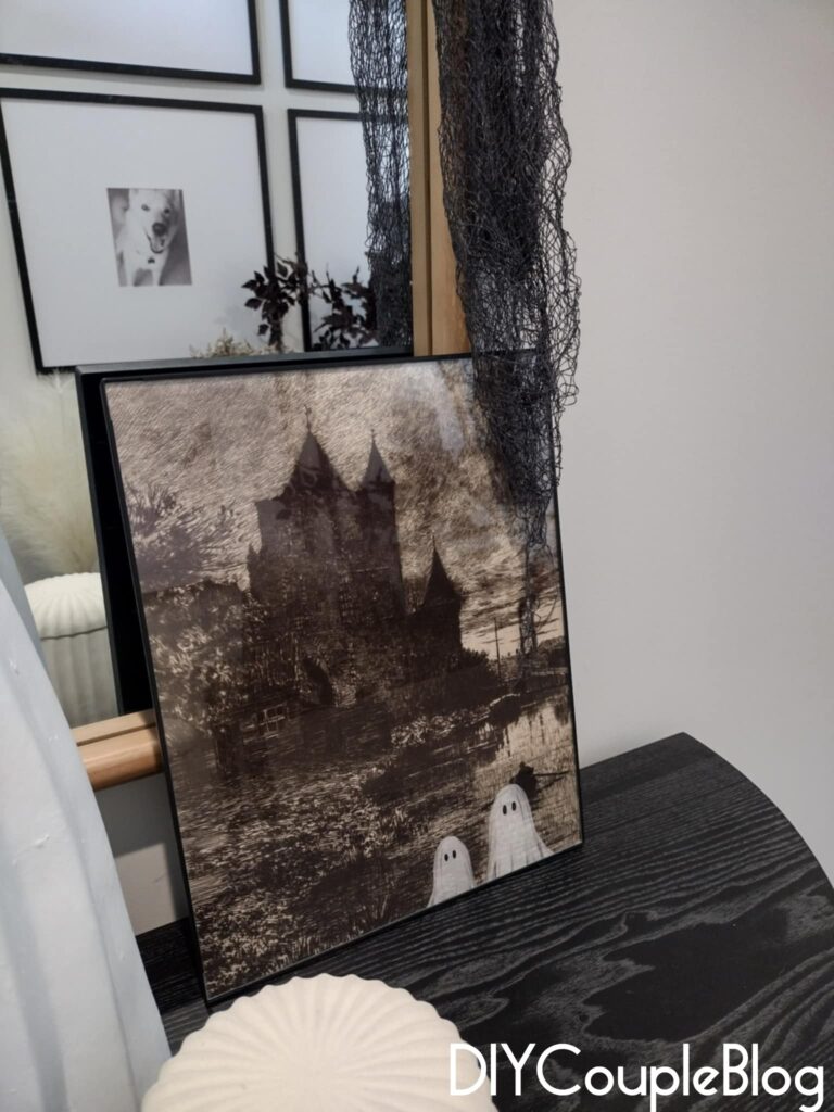 halloween table decor with ghost wall art printable in front of mirror on black console table