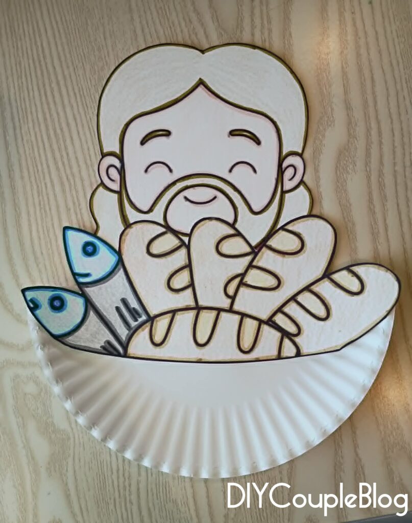 gluing the loaves and fishes printable craft to the front of a paper plate