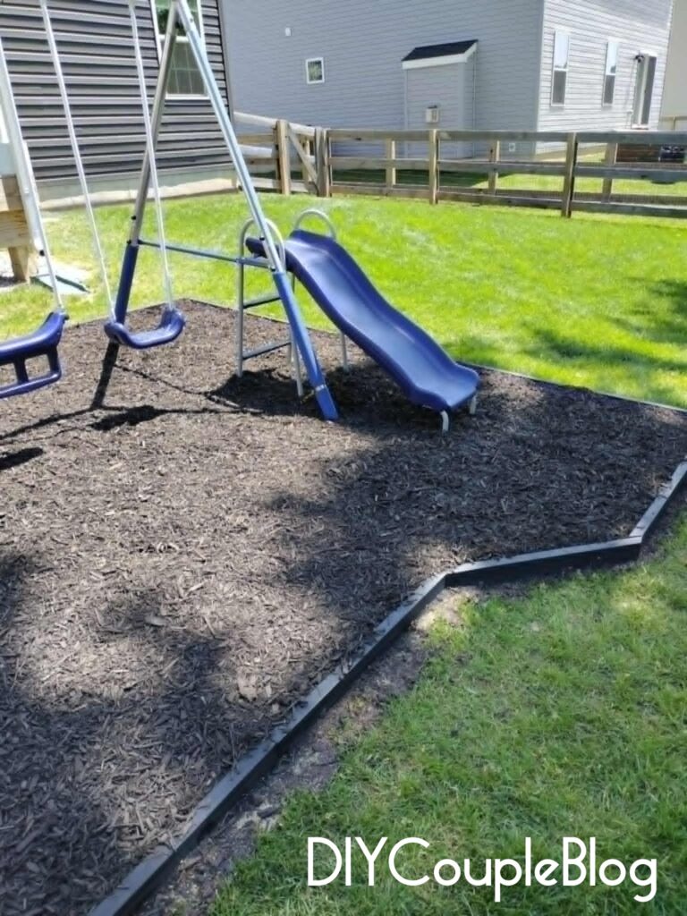 playground view of the enxtended area coming down the side with black border and black mulch