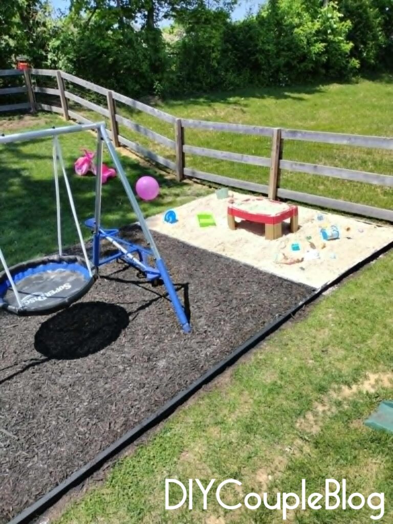 large backyard play area with connecting sandbox