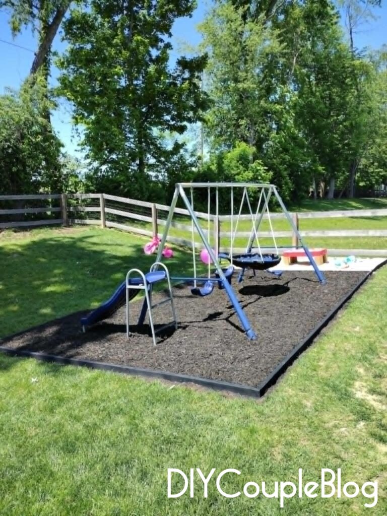 corner view of the playground area in our small yard