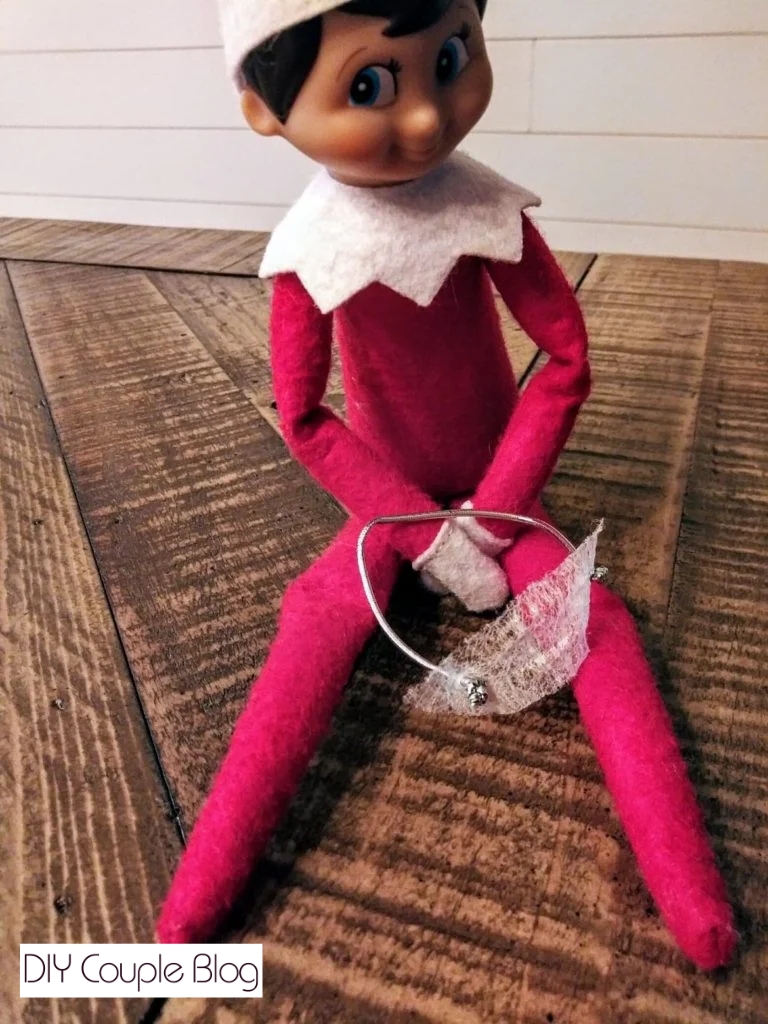 elf sitting with his mini elf mask on his lap