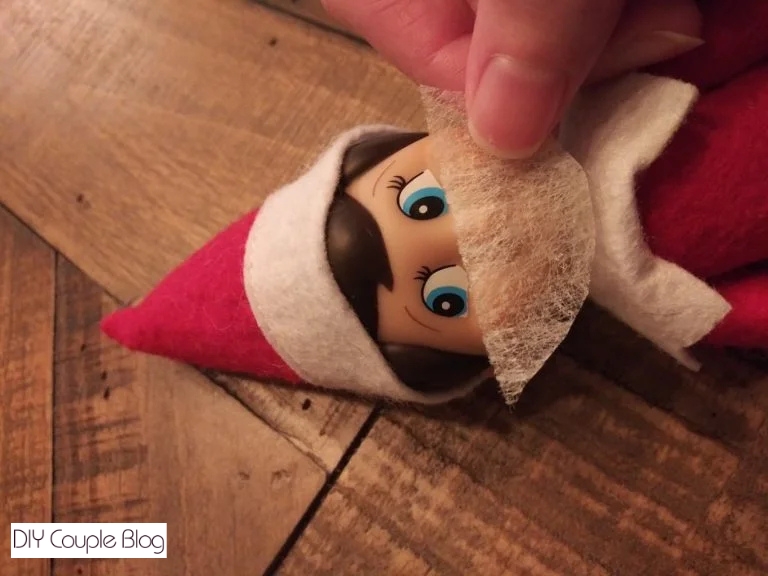 fitting the DIY elf mask on him 