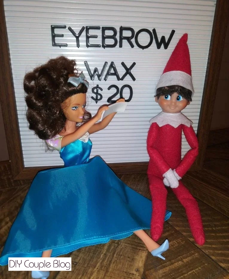 barbie giving Holiday Elf an eyebrow wax 