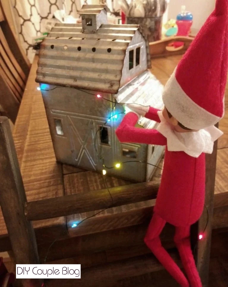 hanging Christmas lights to make it magical for the kids 
