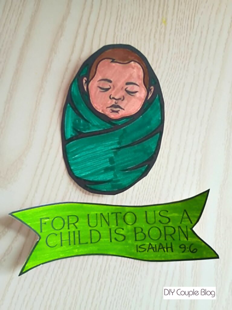 Baby Jesus cut out along with a scripture banner that has been colored 
