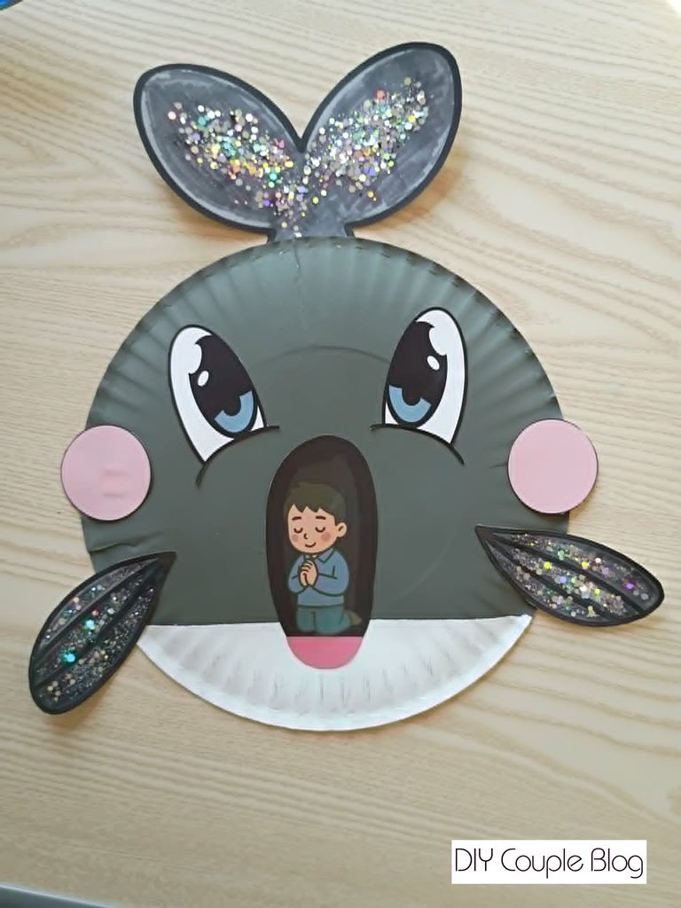 gray painted paper plate with Jonah inside whale's mouth