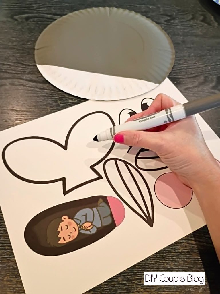 coloring the printable whale tail and fins with markers 