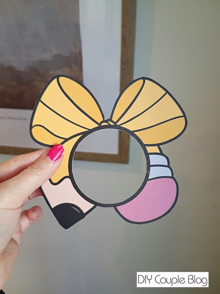 cutting out the center of the ornament print out where photo will go 